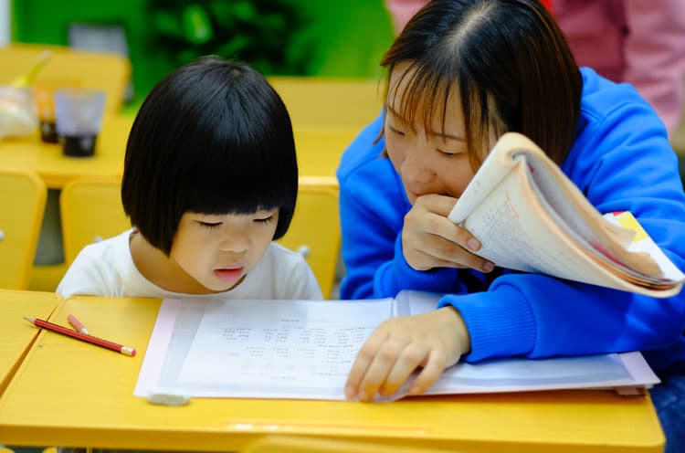 Asian Woman Teaching A Student