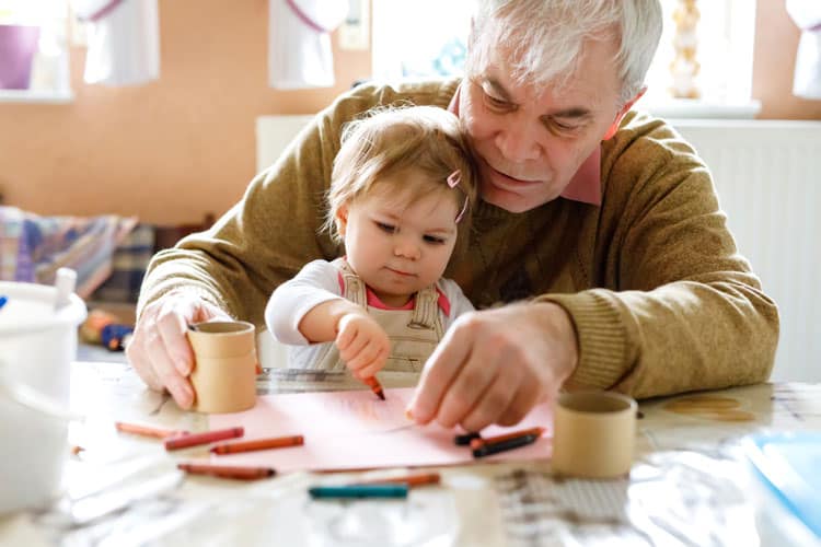Grandfather Drawing With Granddaughter