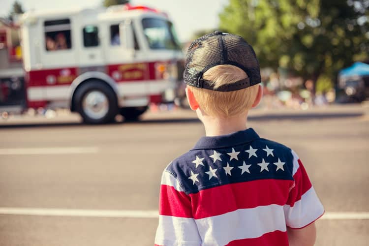 Boy Staying Safe At A 4Th Of July Parade