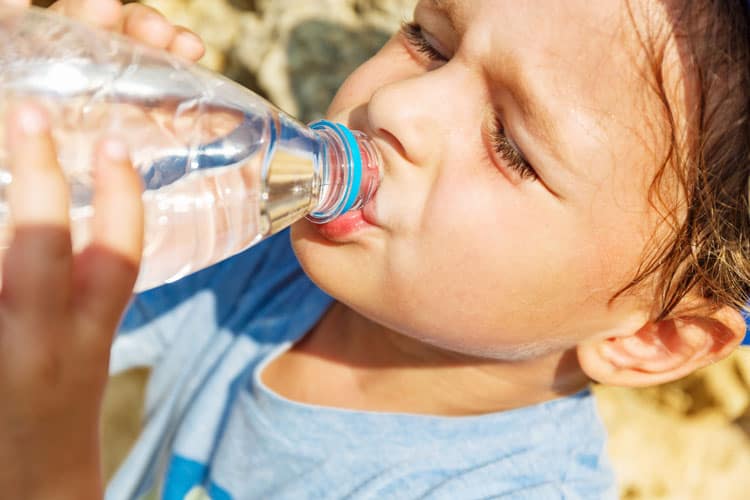 Child Drinking Water On Hot Day