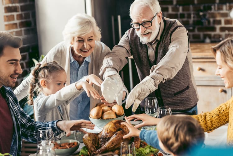 Family Discussing Thanksgiving Facts Around Dinner Table