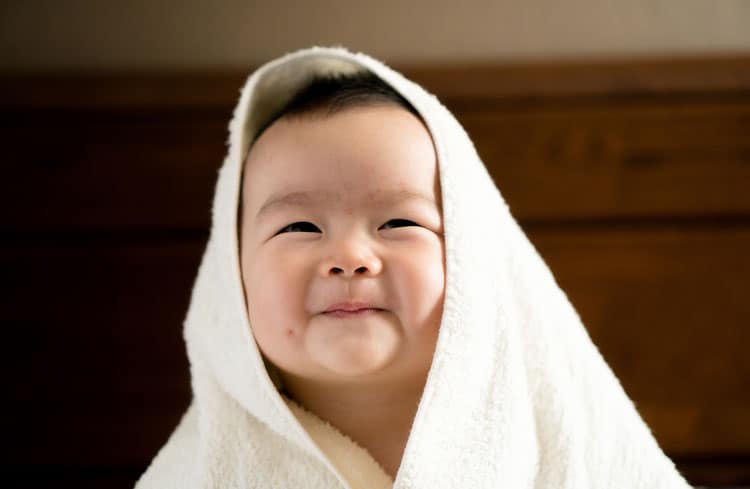 Happy Baby Wrapped In Towel