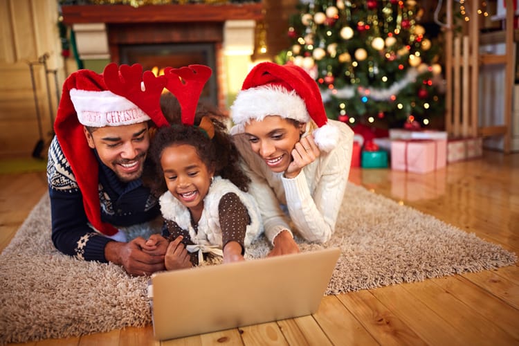 Family Writing List To Santa On The Computer