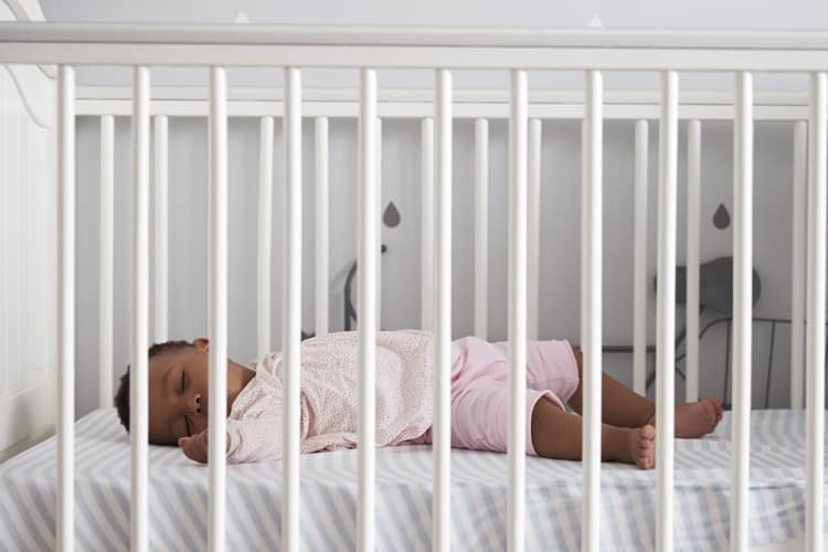 Baby Asleep In A Crib