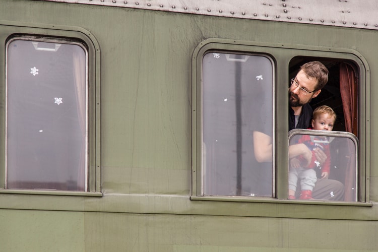 dad and son on train making travel resolutions