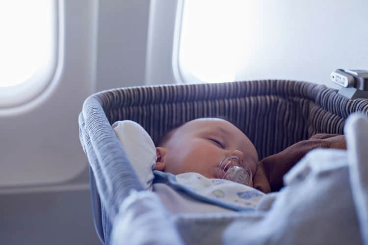 Parents Following Airline Rules On Airplane With Sleeping Baby