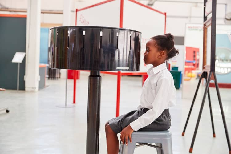 girl watching zoetrope at children's museum