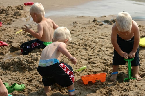 Boys Playing In The Sand For A Fun Staycation