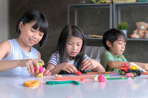 kids playing play-doh during a staycation