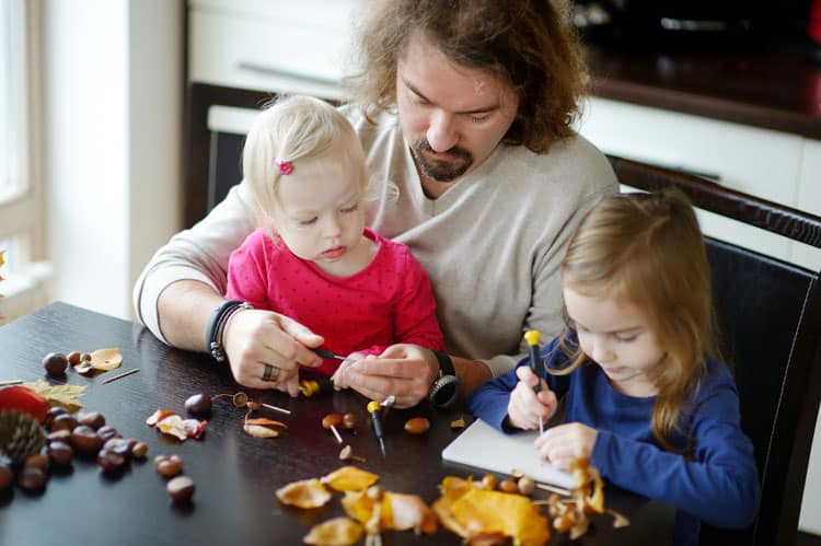 Dad Doing Arts And Crafts With His Girls On A Staycation