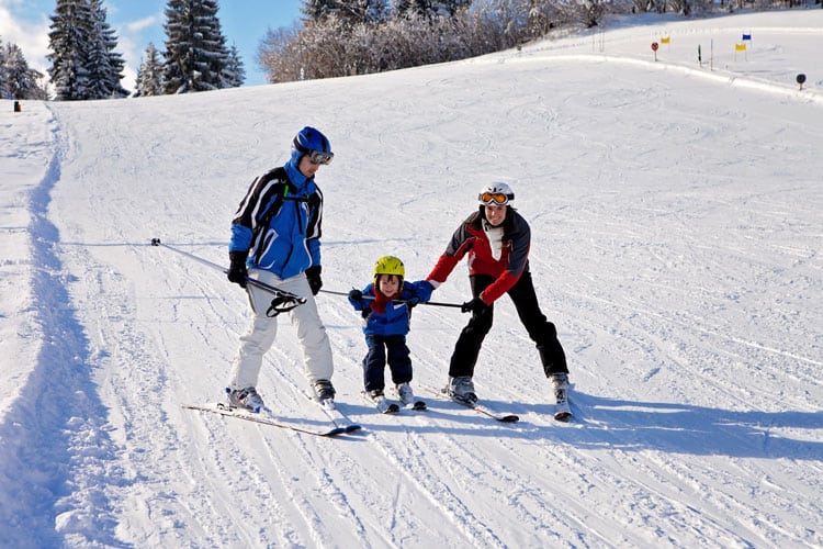 Parents Skiing With Small Child