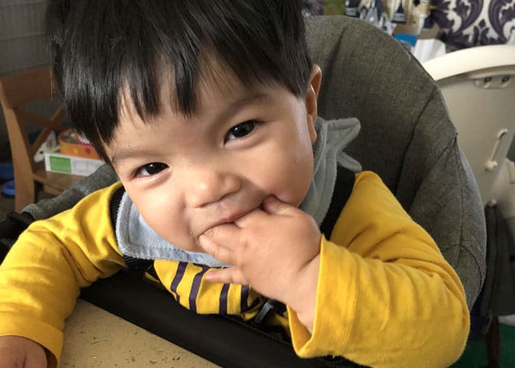 baby licking fingers and yummy travel snacks