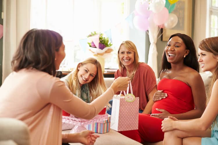 mom opening gifts from baby registry list
