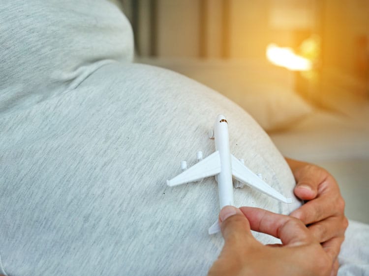 Pregnant Woman Holding Airplane