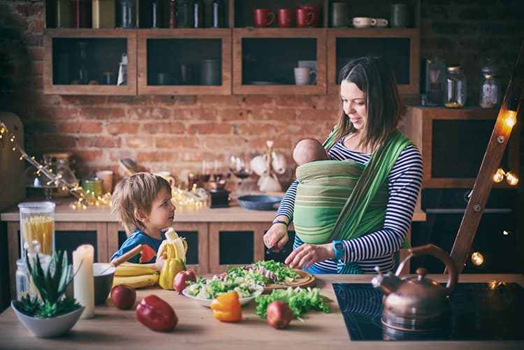 Mother Preparing Healthy Food For Herself And Her Toddler
