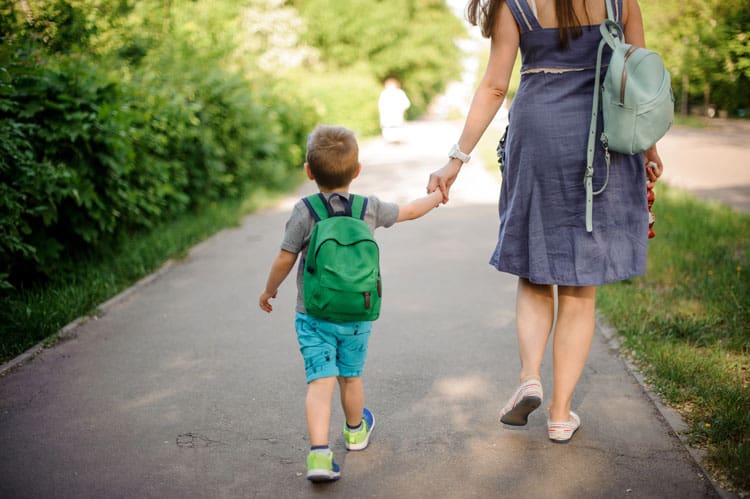 Boy Walking To Kindergarten With His Mom
