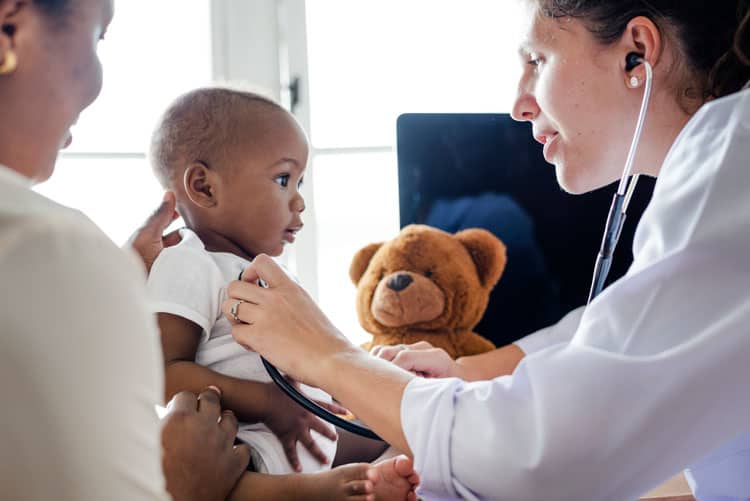 Pediatrician Checking On Small Boy