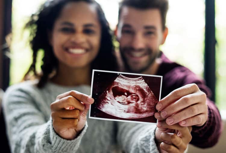 Happy Couple Showing An Ultrasound Picture