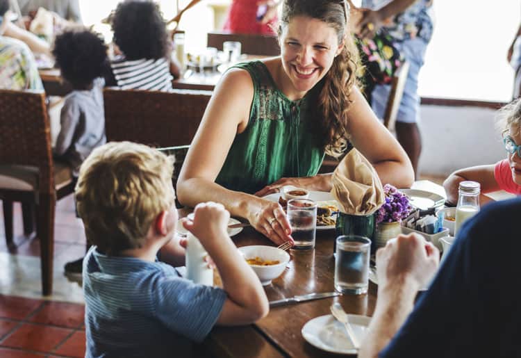 Family Eating At Hotel Restaurant During Family Travel