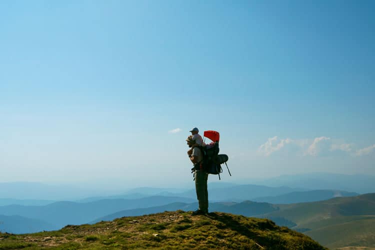 Father And Baby On Top Of A Mountain