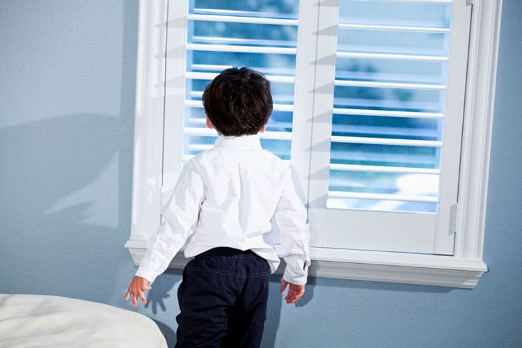 child standing at the window