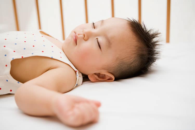 child sleeping in a crib