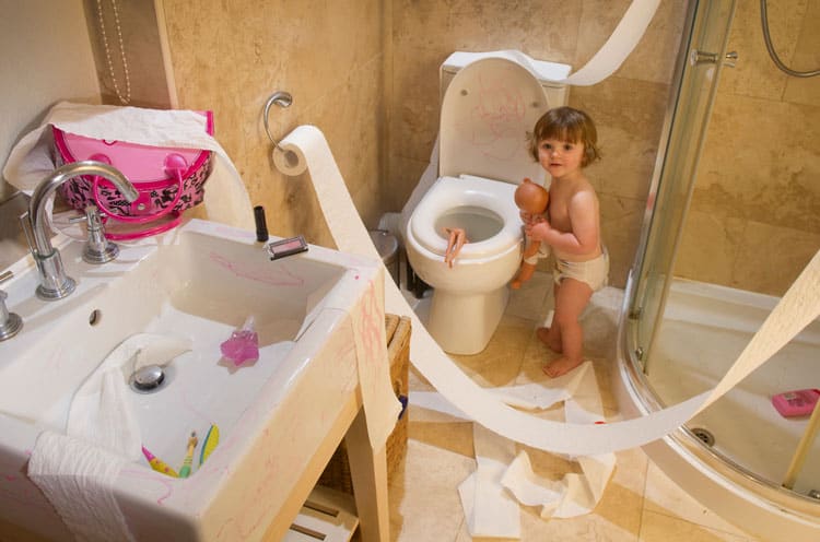 child making a mess in the bathroom