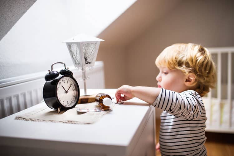 child reaching for unsecured medications