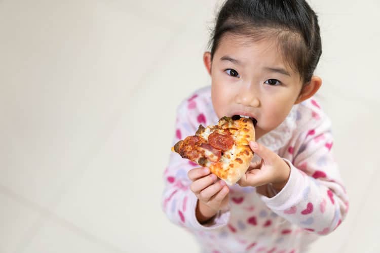girl eating pizza at Bay Area Discovery Museum