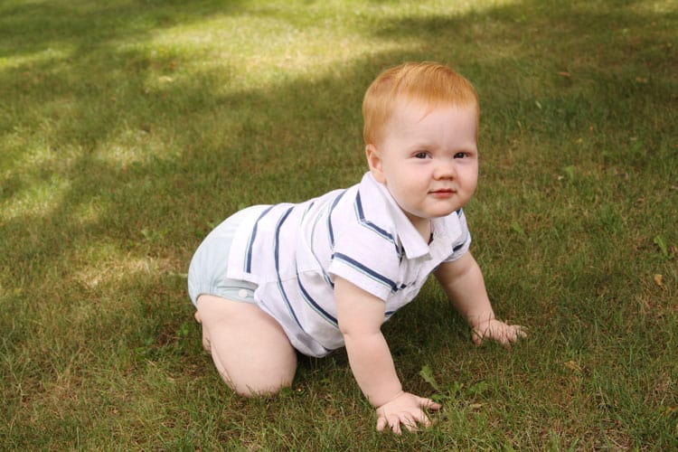 baby crawling in the grass