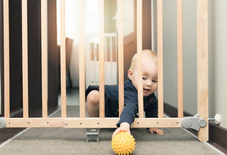 Baby Playing Near Baby Gate