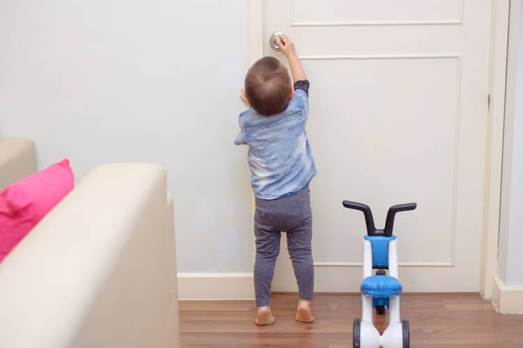 child trying to open a door