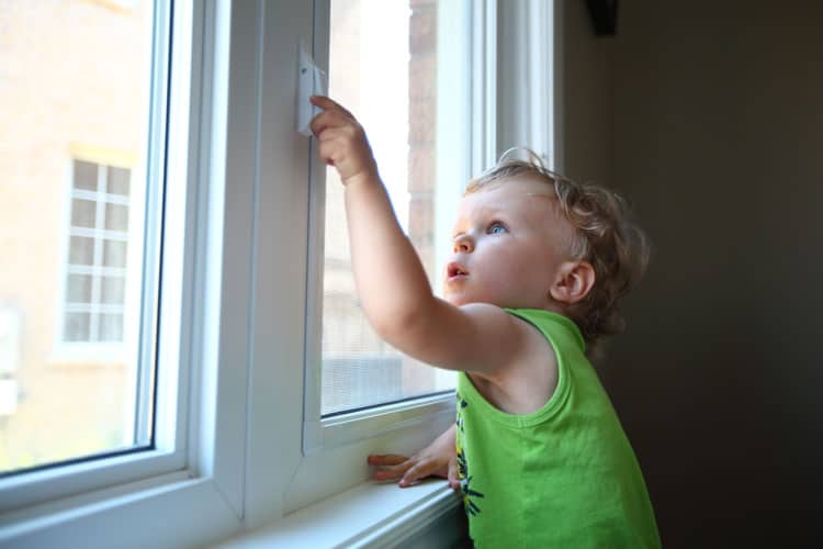 child trying to unlock a window