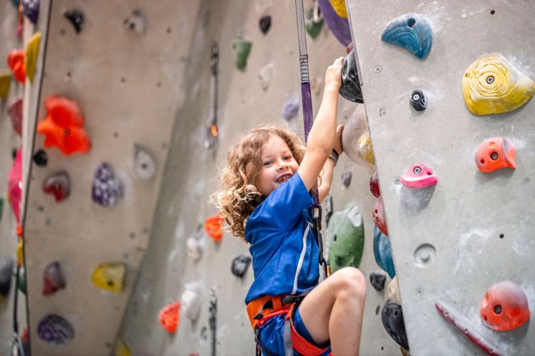 child on rock climbing wall