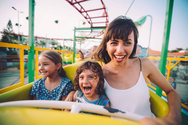 Woman And Kids On Roller Coaster