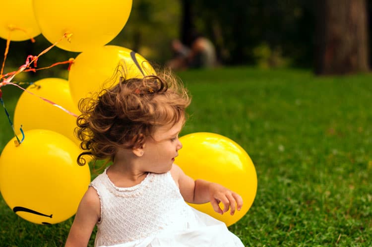 Child Playing With Balloons