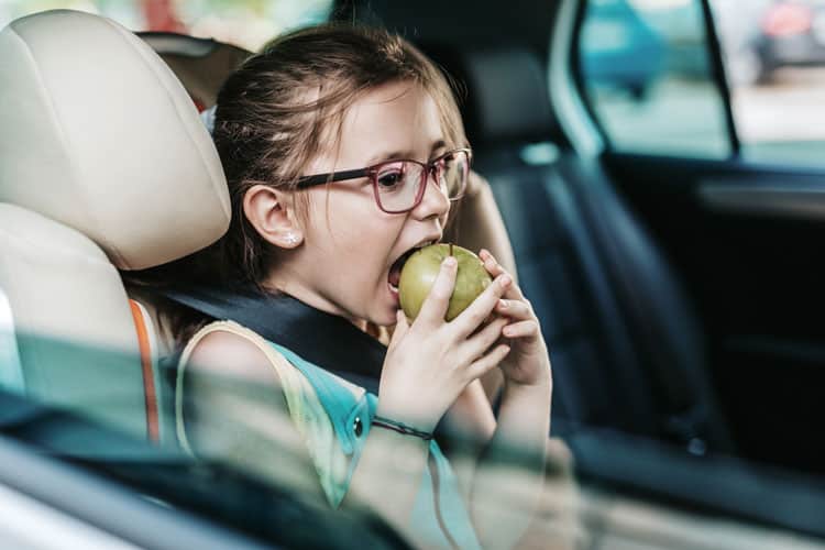 Girl Eating Apple In Car