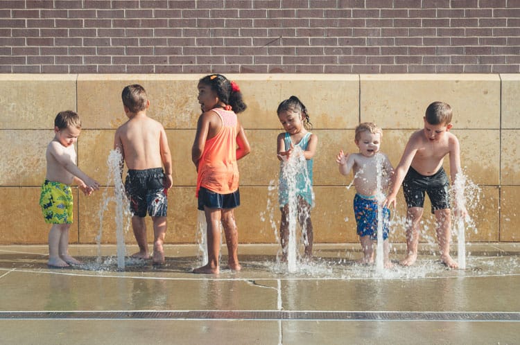 Children Splashing In Fountains