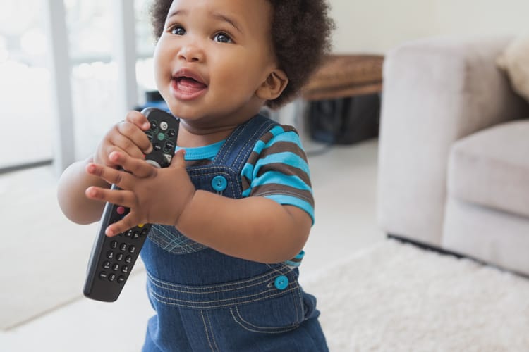 Child Holding A Remote Control