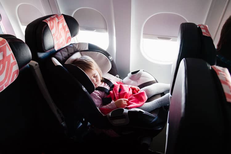 Baby Sleeping In A Car Seat In An Airplane